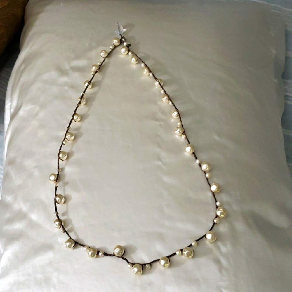 Pearls on woven rope necklace. 32 in total length.